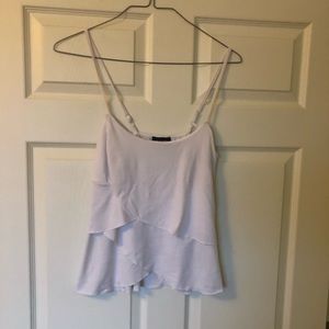 A Byer large white tank adjustable straps. Layered